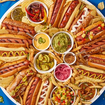 tray full of hot dogs with fun toppings